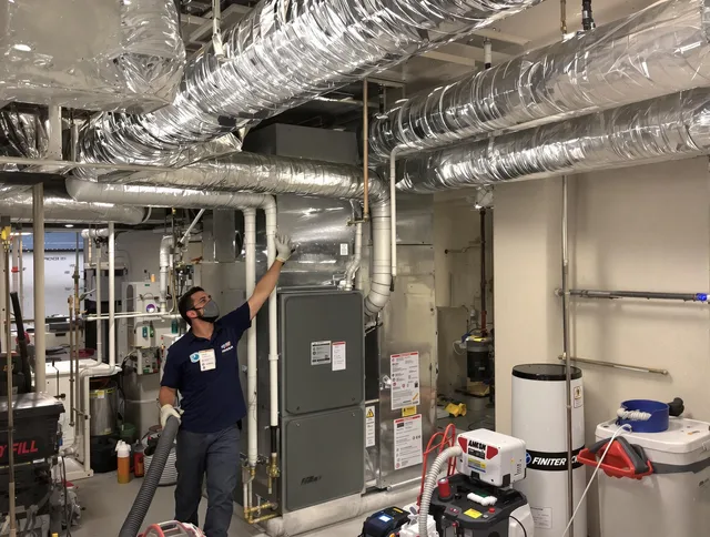 Dartmouth Air Duct Cleaning specialist performing thorough furnace duct cleaning in a Dartmouth residence