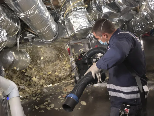 Dartmouth Air Duct Cleaning specialist operating negative pressure cleaning equipment for thorough duct maintenance in Dartmouth
