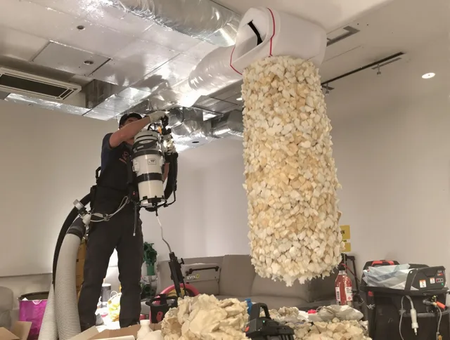 Dartmouth Air Duct Cleaning technician performing precision vacuum insulation removal in a residential property in Dartmouth